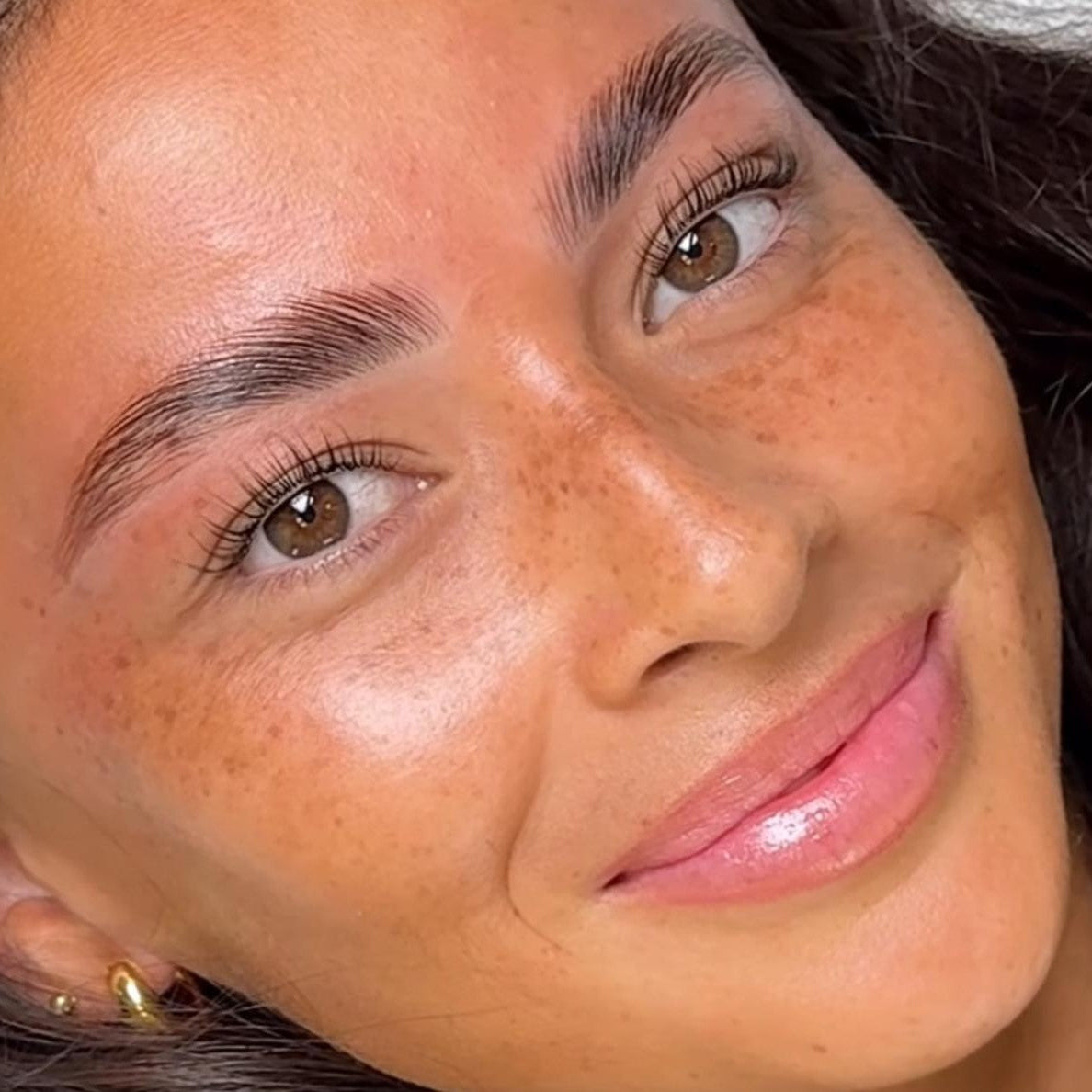 Smiling client after a professional brow lamination at Brazilliance Spa, Cape Town.